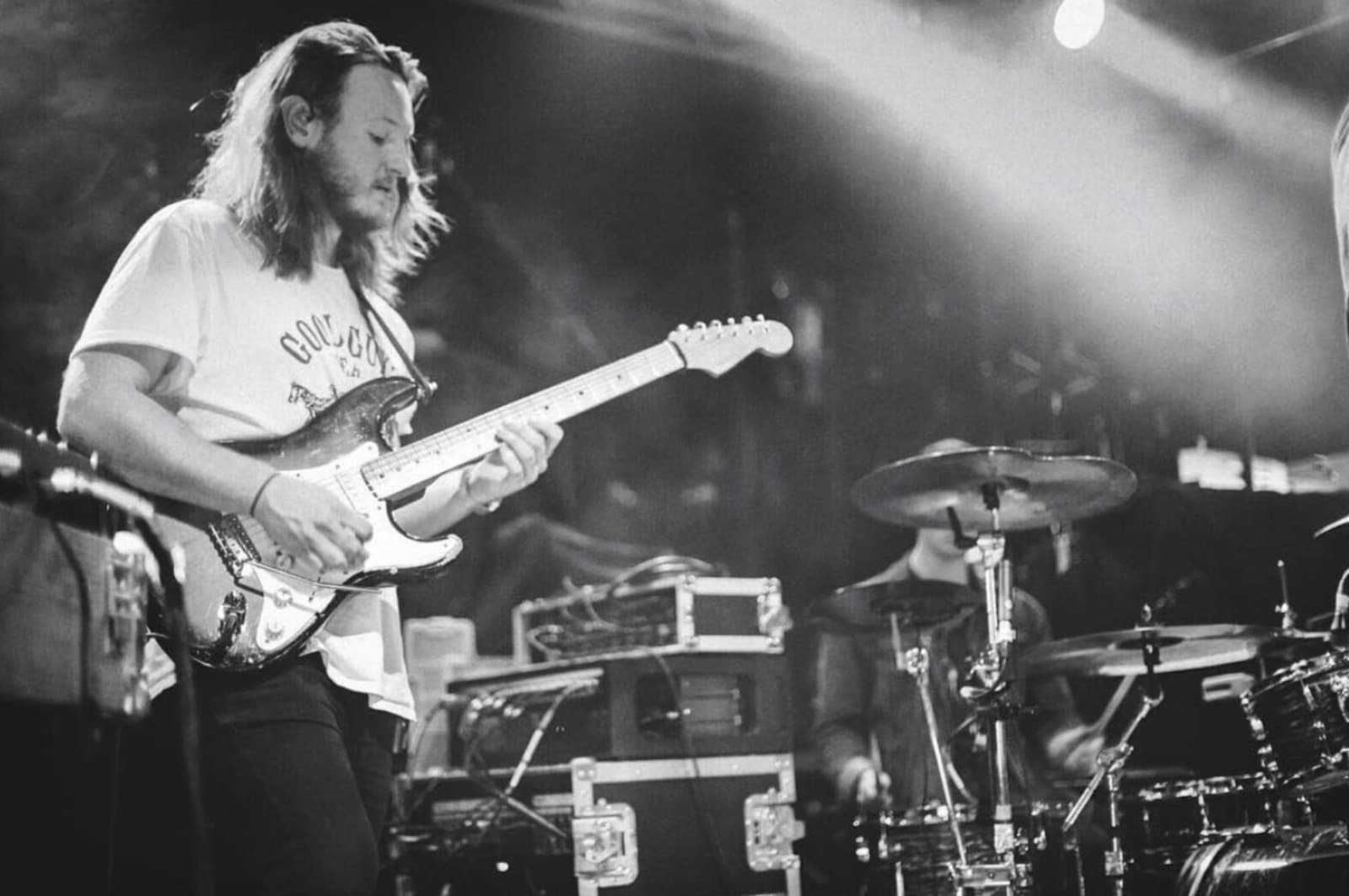 Chris Hall on stage with a Stratocaster during a live performance