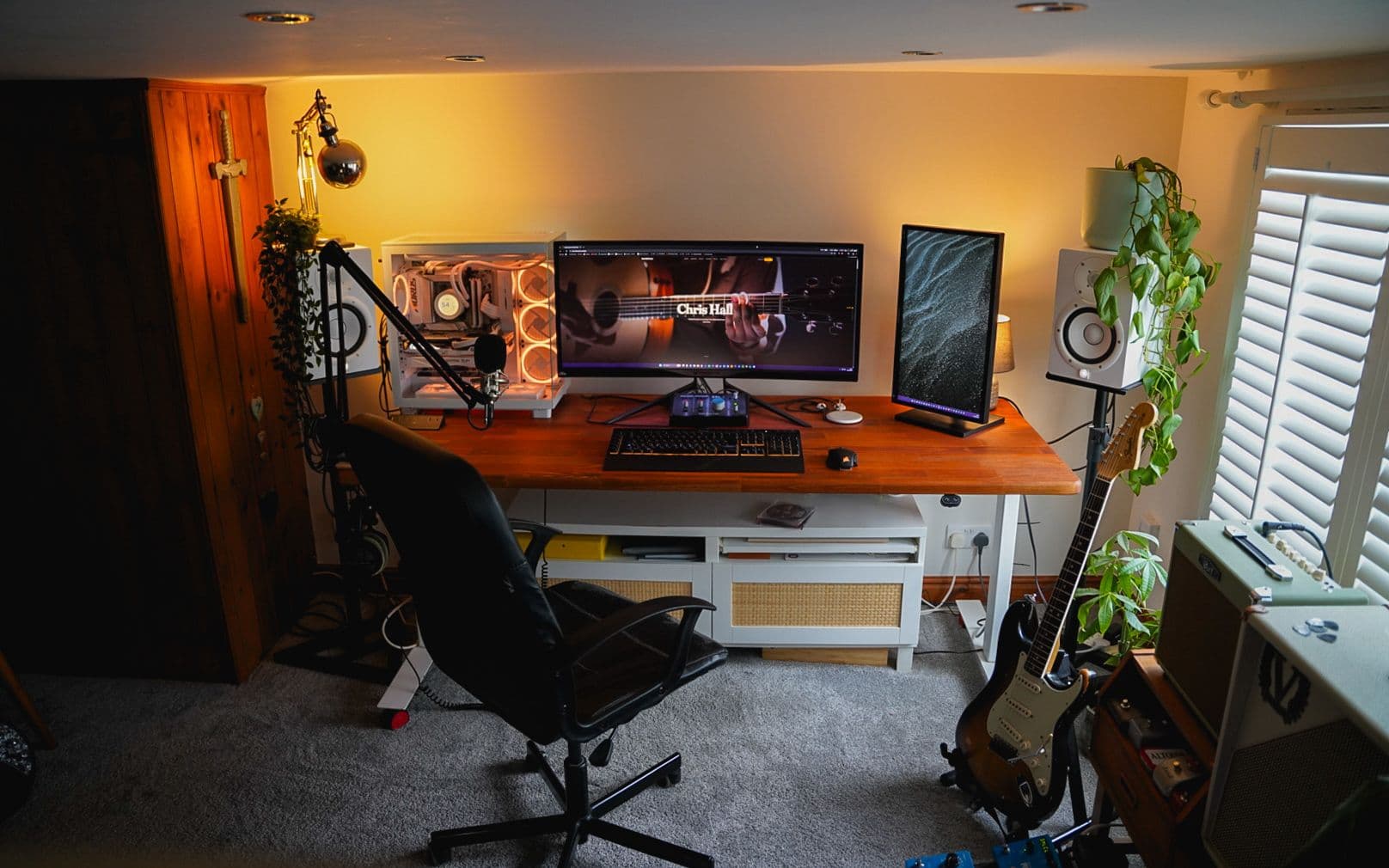 Chris Hall's home studio — dual monitors with the Chris Hall Guitar site, Stratocaster, studio monitors and plants